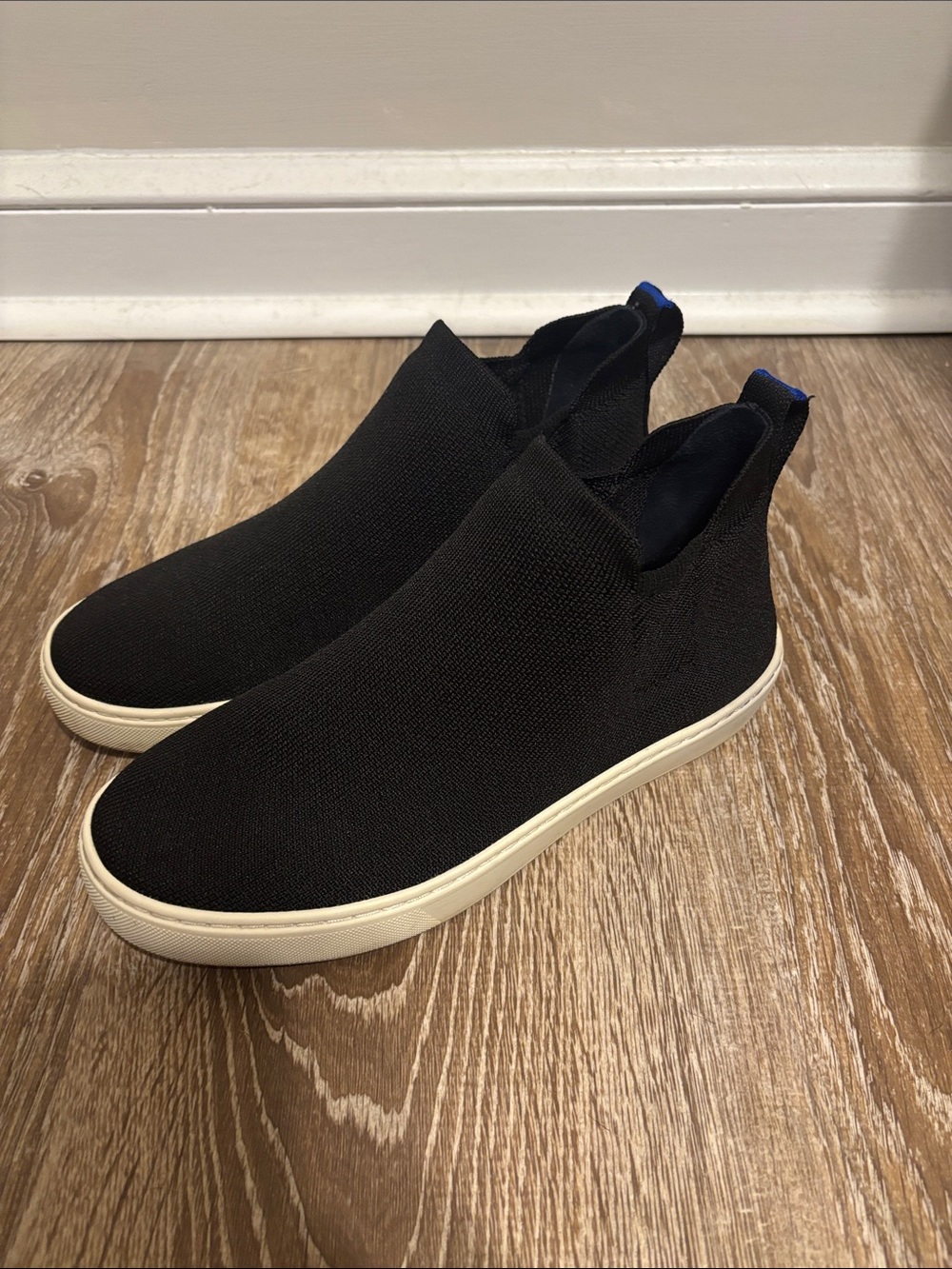 Rothy's Black Knit Slip-On Sneakers with White Sole and Blue Heel Tab